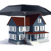 Insurance concept -  house under umbrella