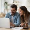 Happy,Young,Couple,Husband,And,Wife,Using,Laptop,Computer,Looking